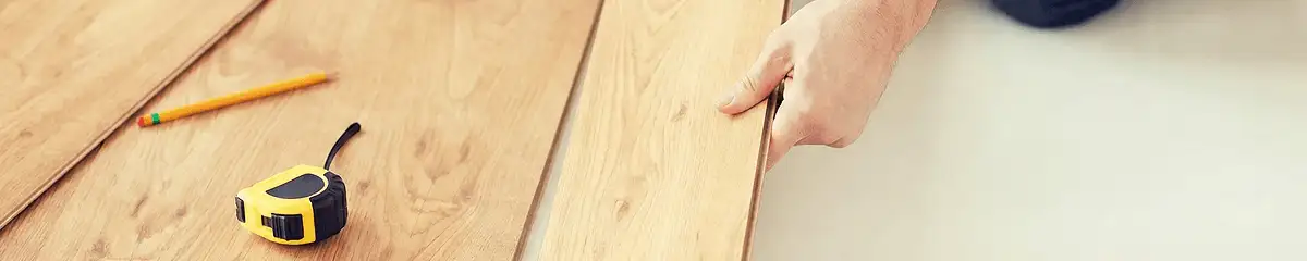 A professional installing wood flooring in Dallas, TX