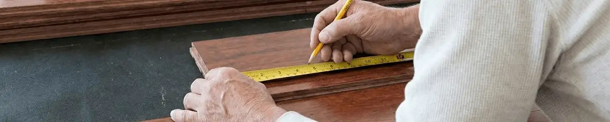 A professional installing wood flooring in Dallas, TX